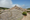 Large rock cairn atop Dorr Mountain in Acadia National Park, marking the summit against a backdrop of rugged granite and open sky.
